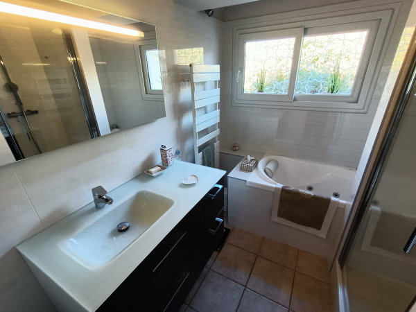 En plus de deux salles d'eau, une salle de bain avec baignoire balnéo et douche.