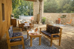 Espace apéro et repas sur terrasse couverte pour être à l'ombre ou à l'abri de la pluie